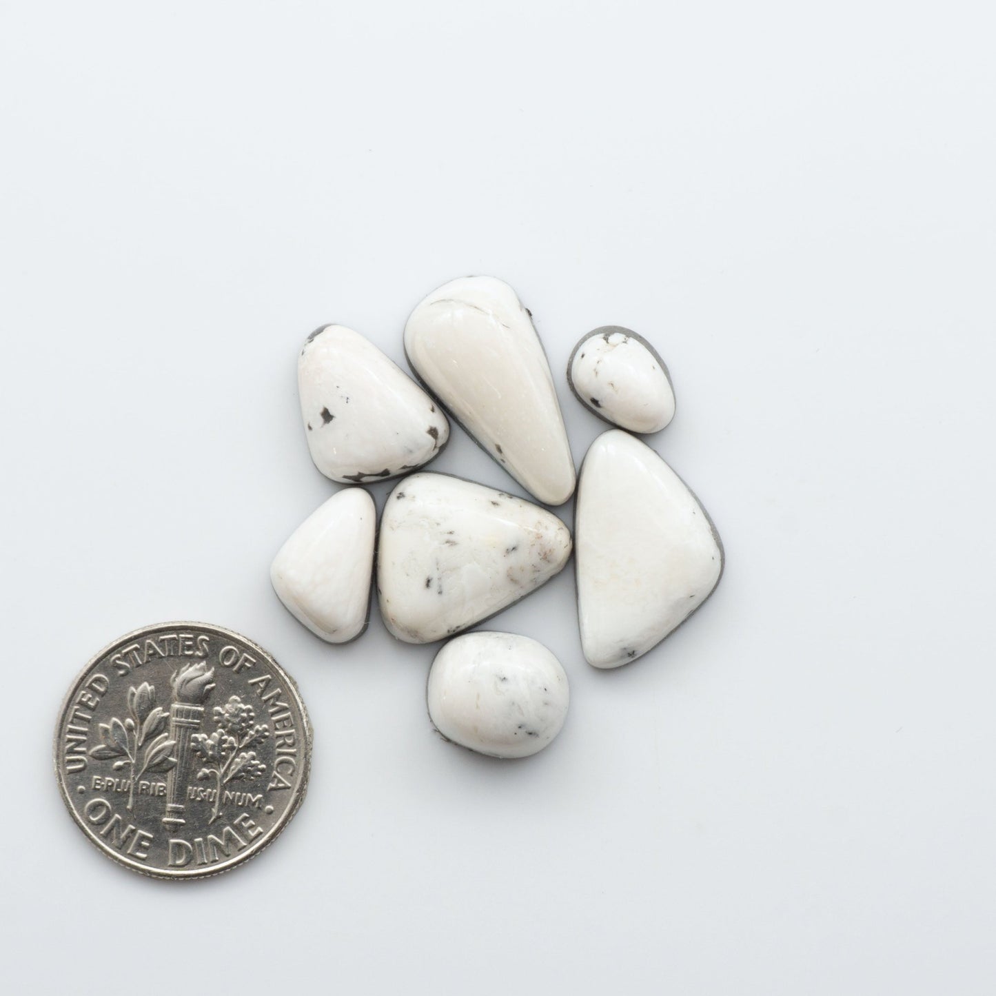 These Natural White Buffalo Stone Cabochons are semi-precious gemstones cut into shapes ideal for jewelry-making