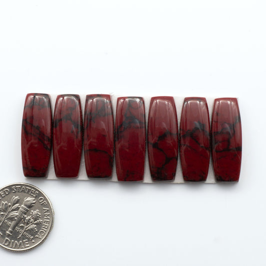 Bloody Bison Jasper is a composite stone with a vibrant red hue and black matrix that creates a strong impression and a touch of opulence to any jewelry piece.