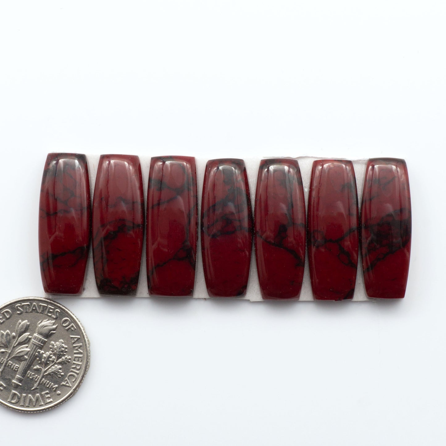 Bloody Bison Jasper is a composite stone with a vibrant red hue and black matrix that creates a strong impression and a touch of opulence to any jewelry piece.