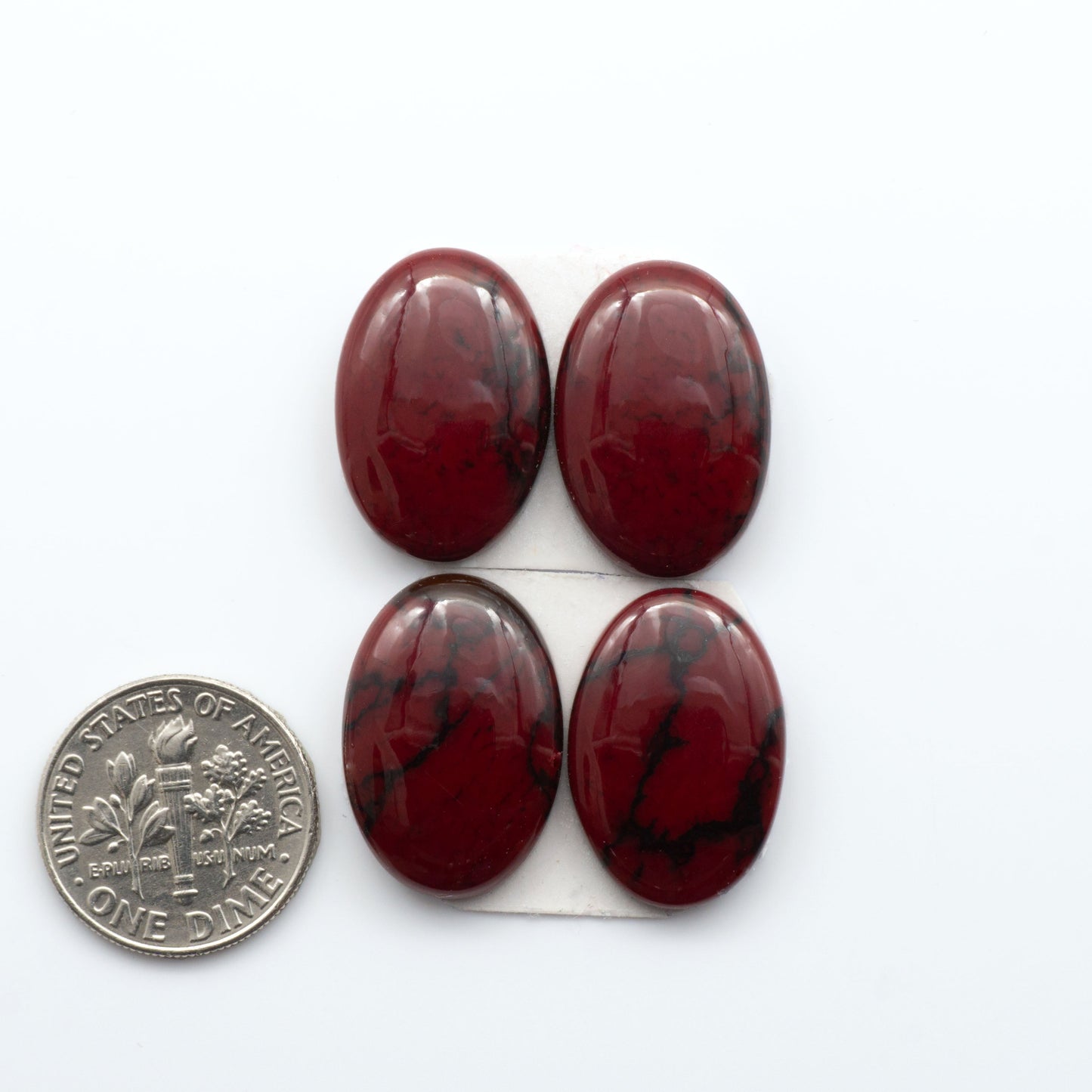 Bloody Bison Jasper is a composite stone with a vibrant red hue and black matrix that creates a strong impression and a touch of opulence to any jewelry piece.