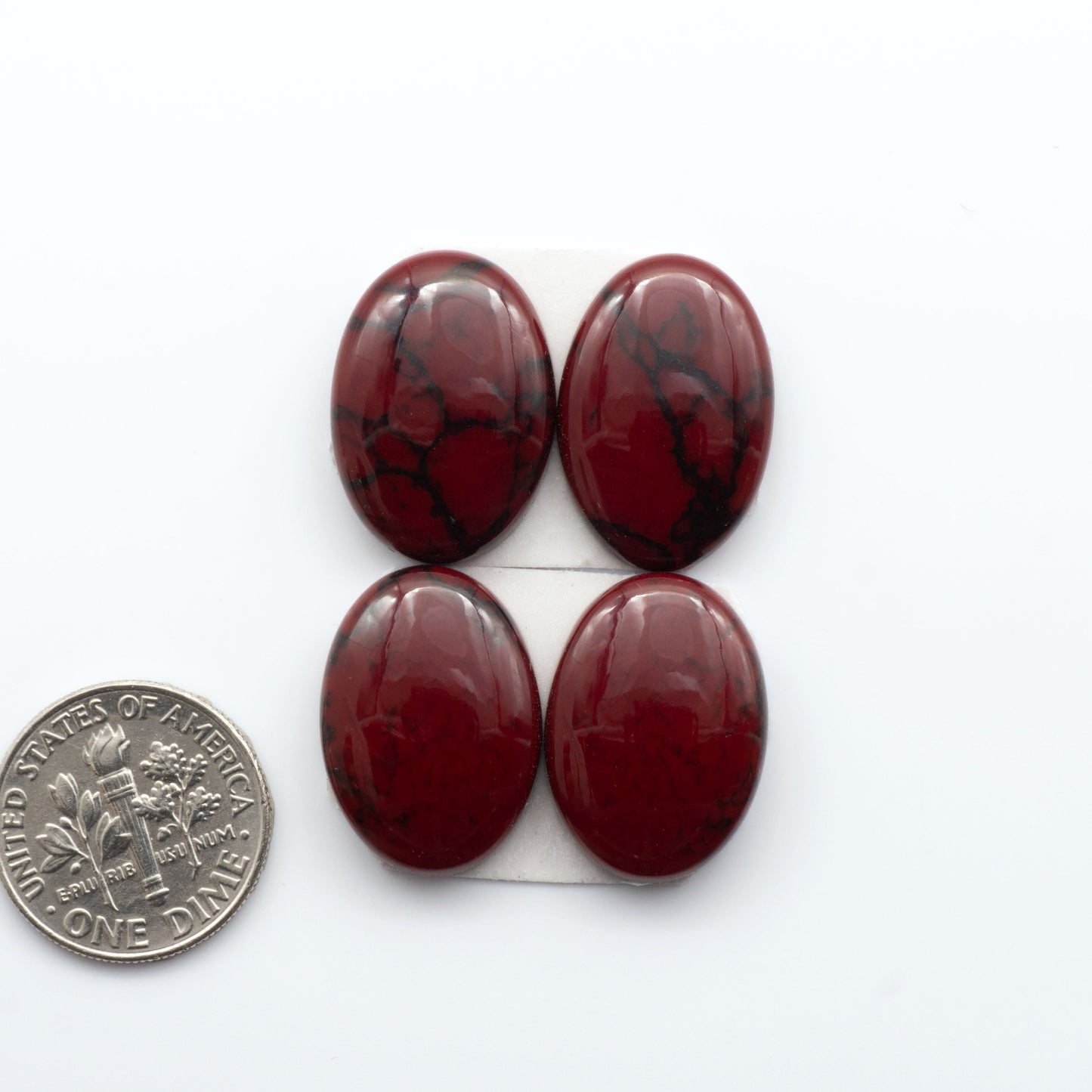 Bloody Bison Jasper is a composite stone with a vibrant red hue and black matrix that creates a strong impression and a touch of opulence to any jewelry piece.