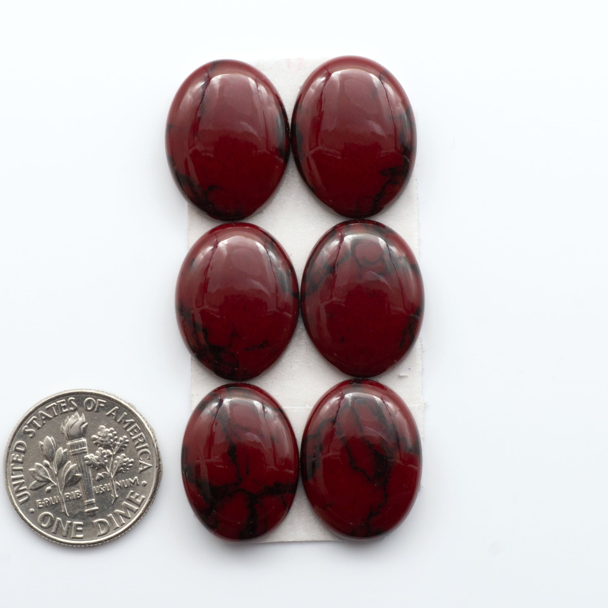 Bloody Bison Jasper is a composite stone with a vibrant red hue and black matrix that creates a strong impression and a touch of opulence to any jewelry piece.