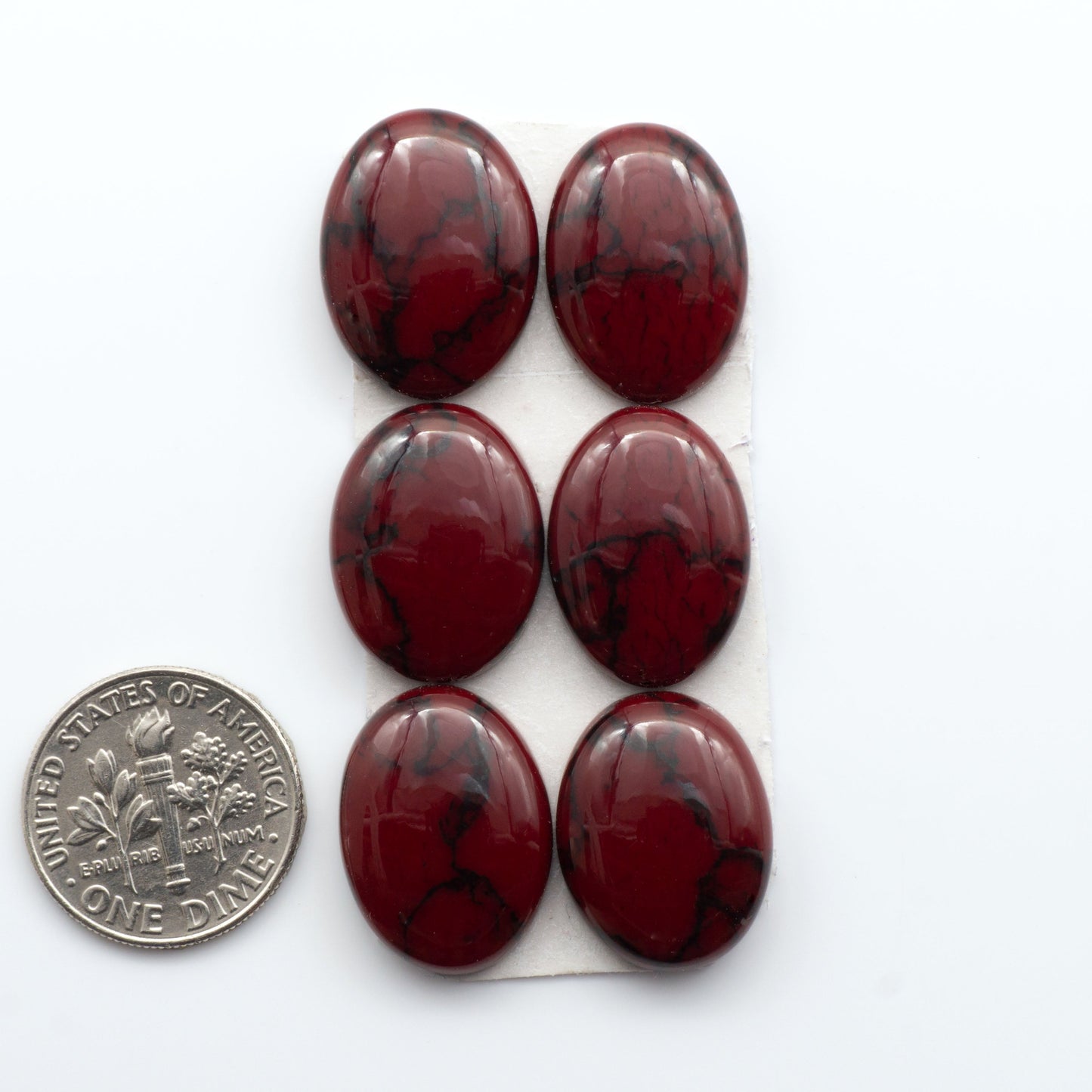 Bloody Bison Jasper is a composite stone with a vibrant red hue and black matrix that creates a strong impression and a touch of opulence to any jewelry piece.