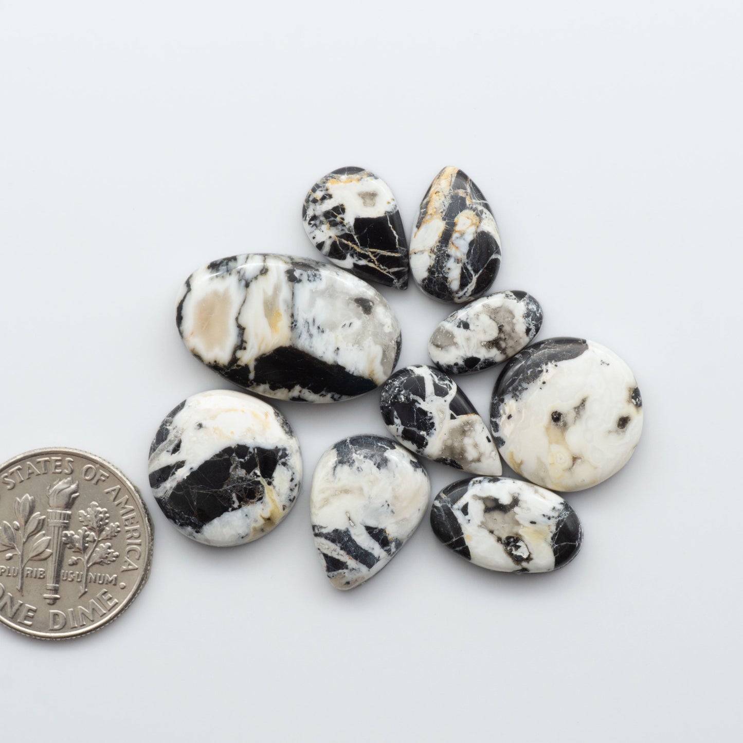 Natural White Buffalo Stone Cabochons are semi-precious gemstones cut into shapes ideal for jewelry-making and crafting and are backed for added strength. 