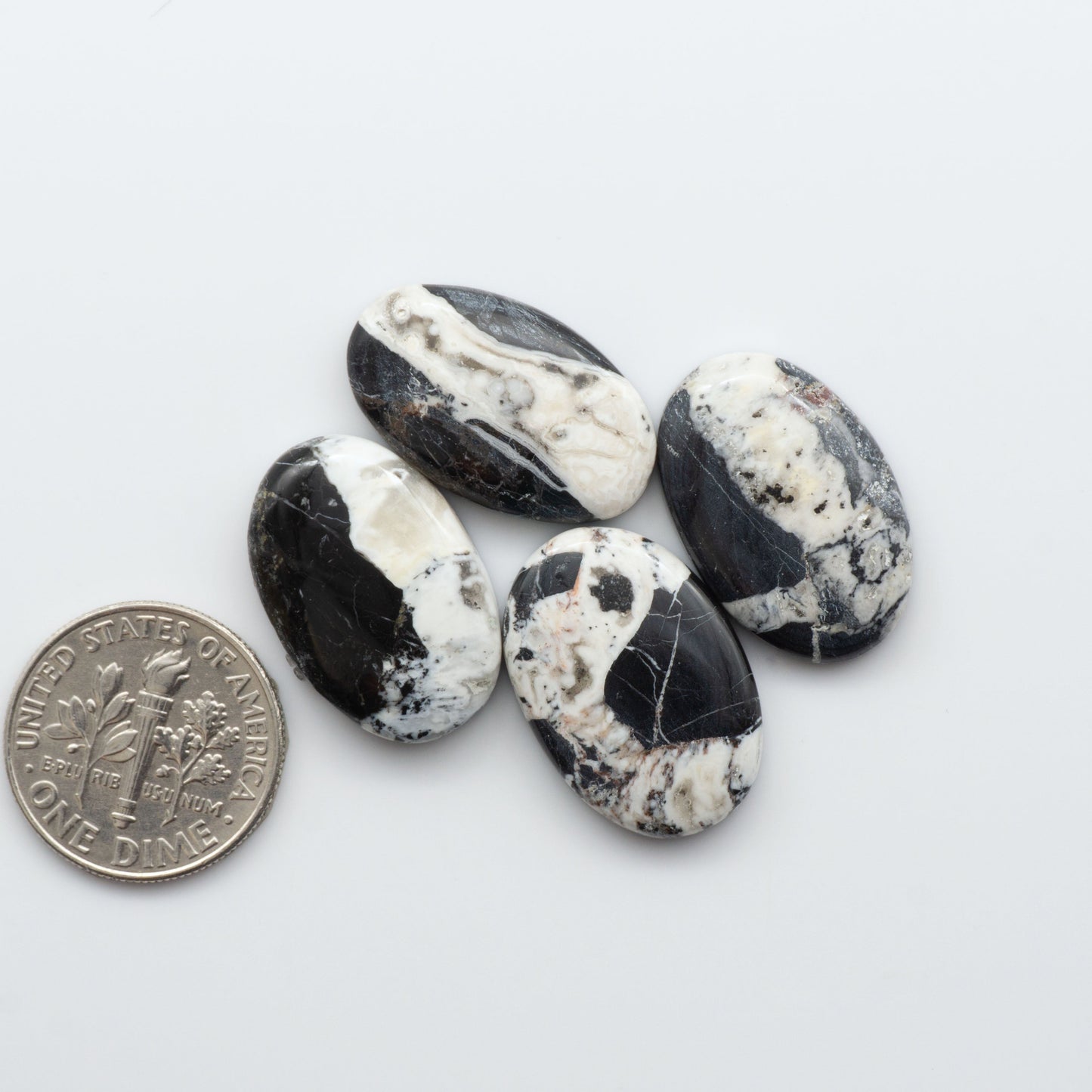 Natural White Buffalo Stone Cabochons are semi-precious gemstones cut into shapes ideal for jewelry-making and crafting and are backed for added strength. 