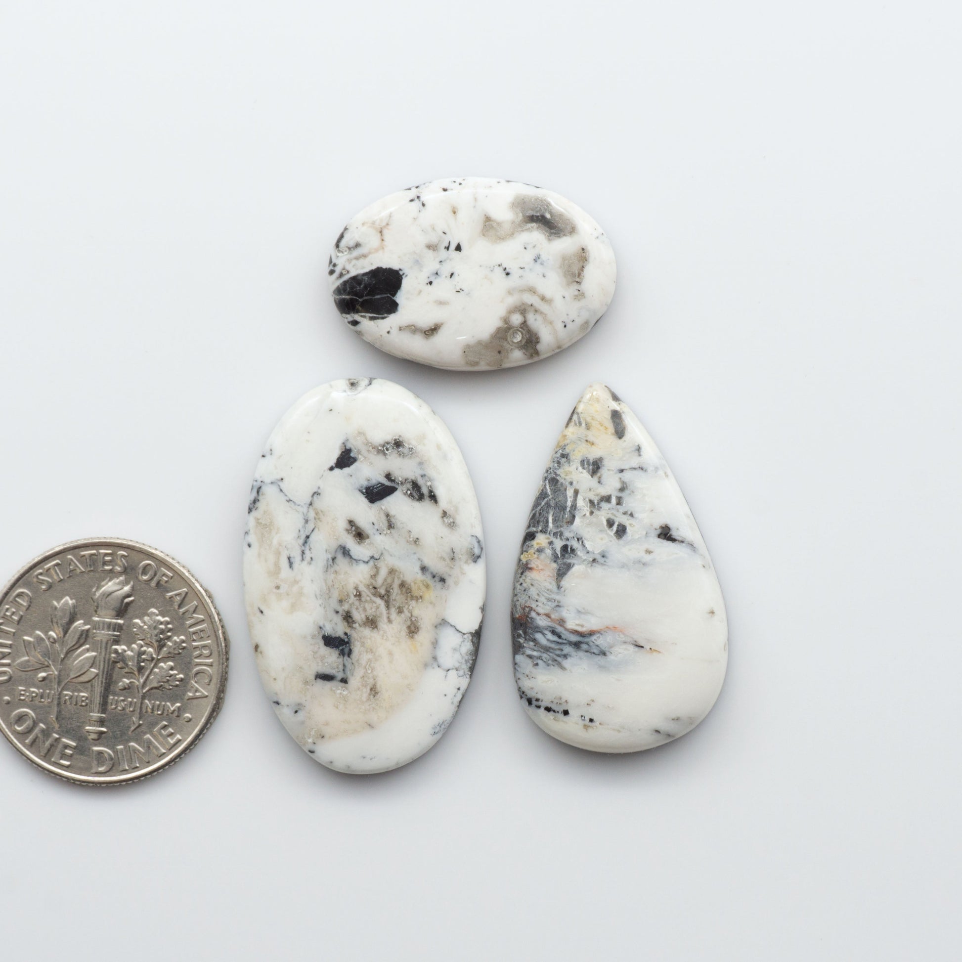 Natural White Buffalo Stone Cabochons are semi-precious gemstones cut into shapes ideal for jewelry-making and crafting and are backed for added strength. 