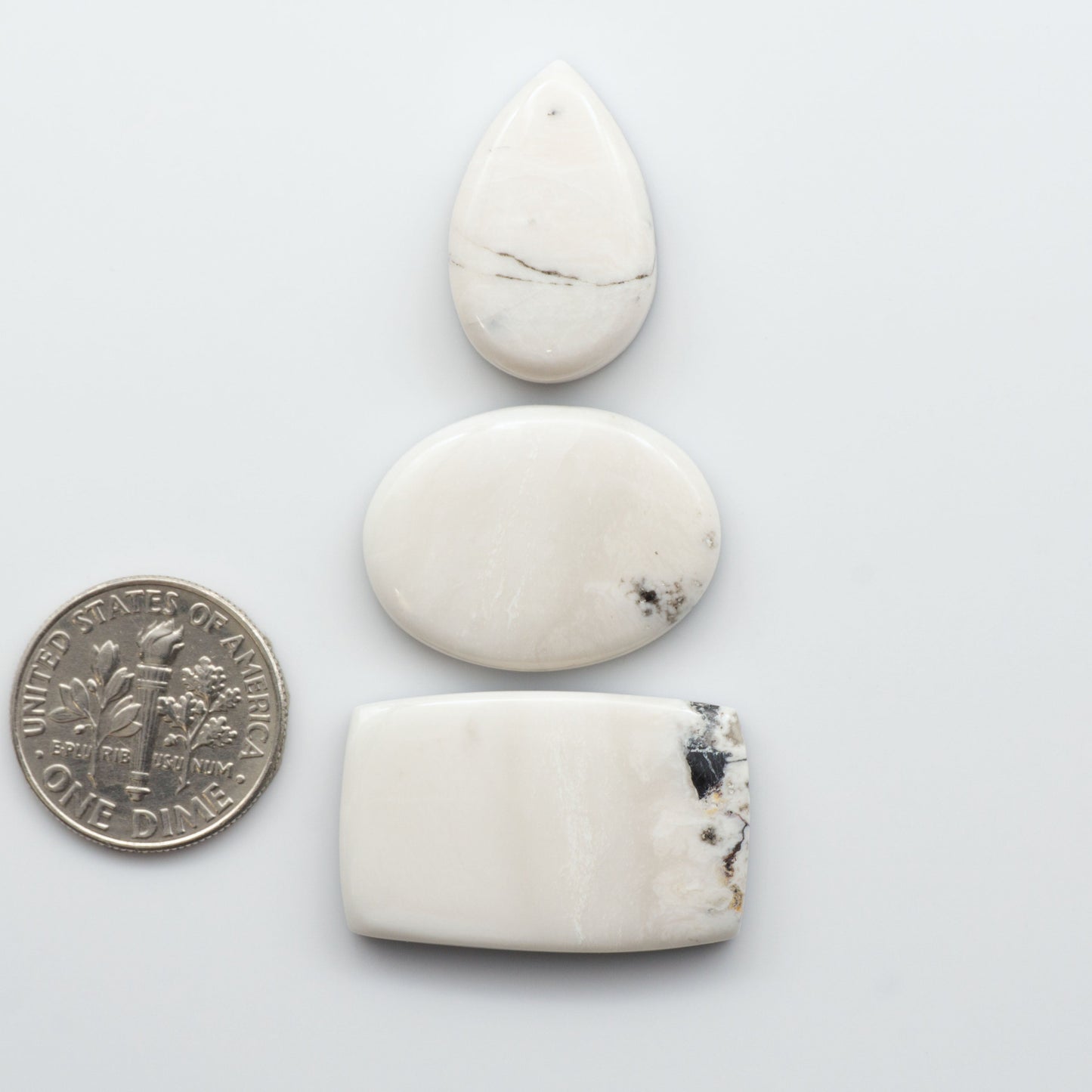 Natural White Buffalo Stone Cabochons are semi-precious gemstones cut into shapes ideal for jewelry-making and crafting and are backed for added strength.