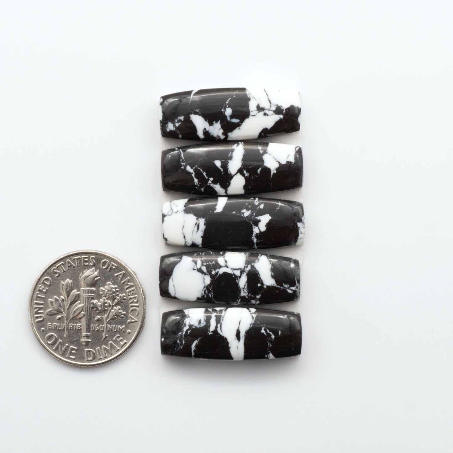 These White Buffalo Cabochons are expertly cut and polished from composite material, resulting in a stunning and long-lasting gemstone.

