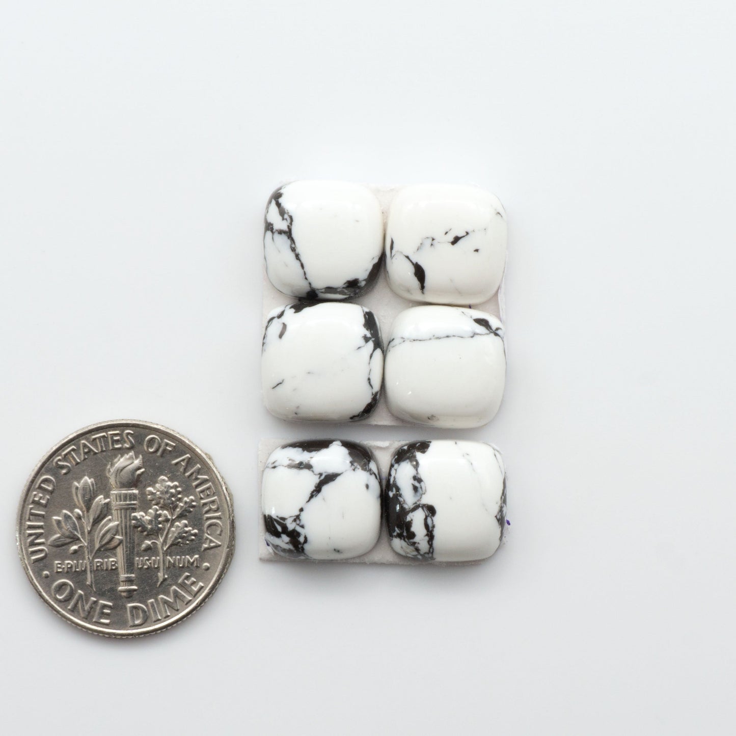 These White Buffalo Cabochons are expertly cut and polished from composite material, resulting in a stunning and long-lasting gemstone.

