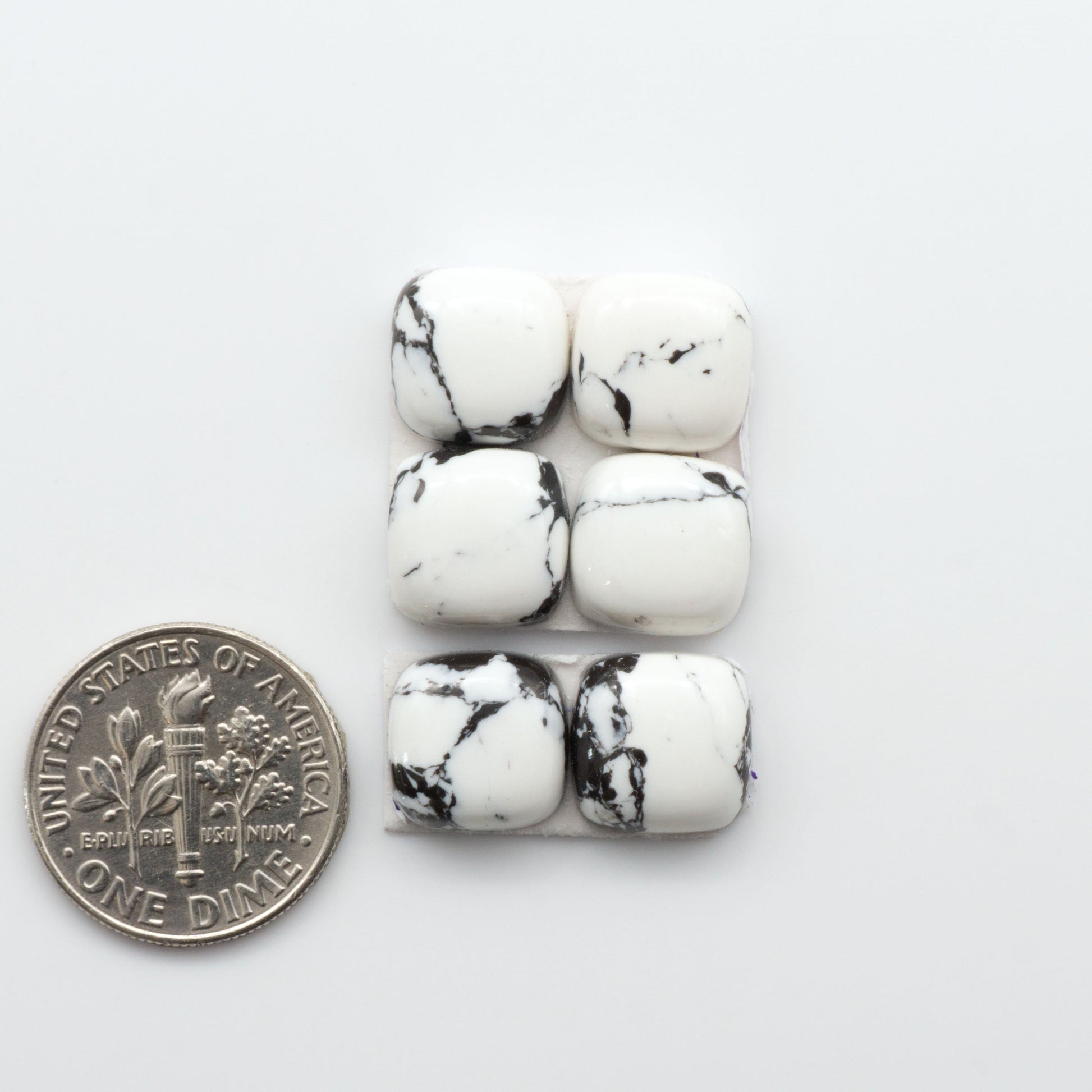 These White Buffalo Cabochons are expertly cut and polished from composite material, resulting in a stunning and long-lasting gemstone.

