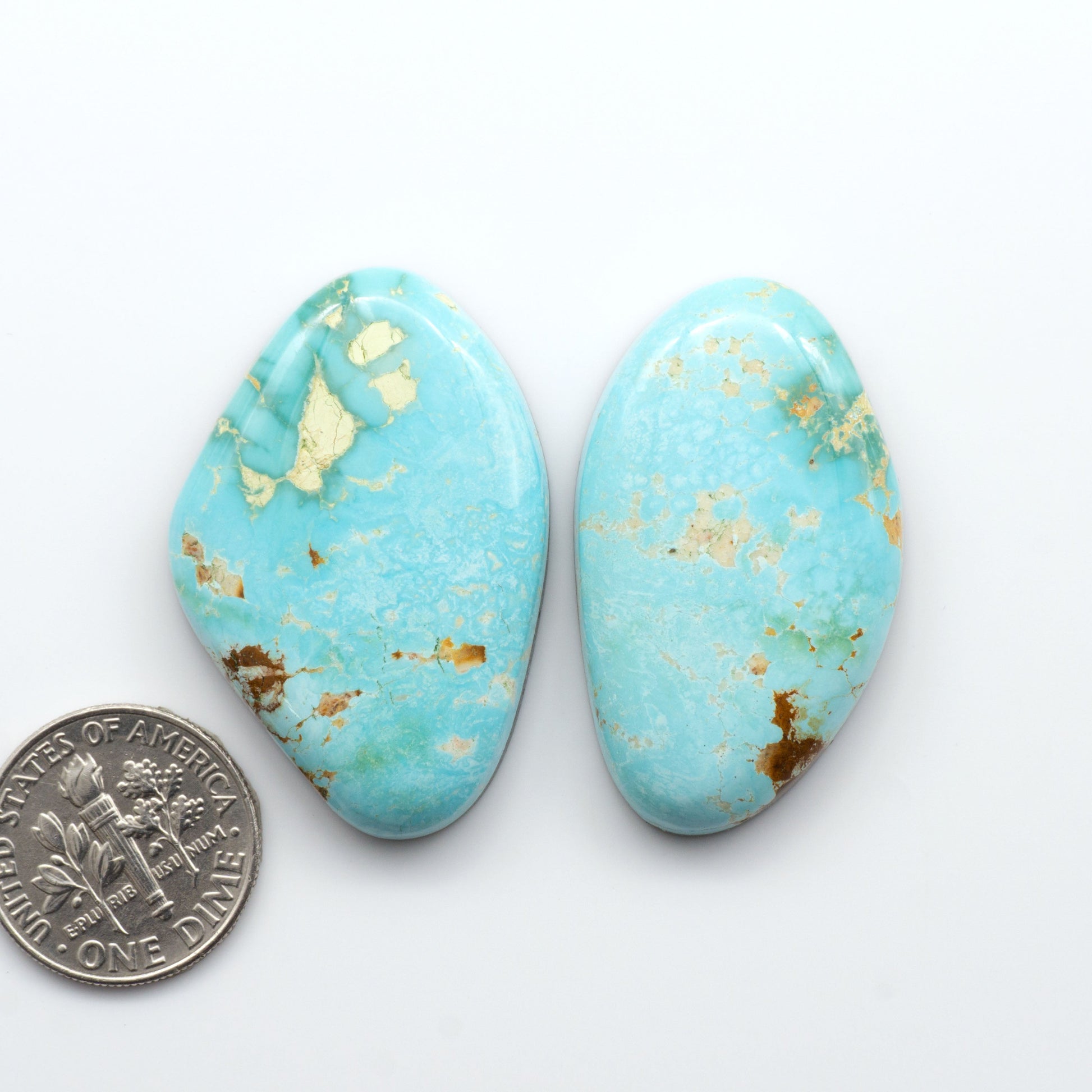 Royston Turquoise cabochons are famous for their distinctive matrix and unique green and blue hues, making them a favored option among jewelry designers.